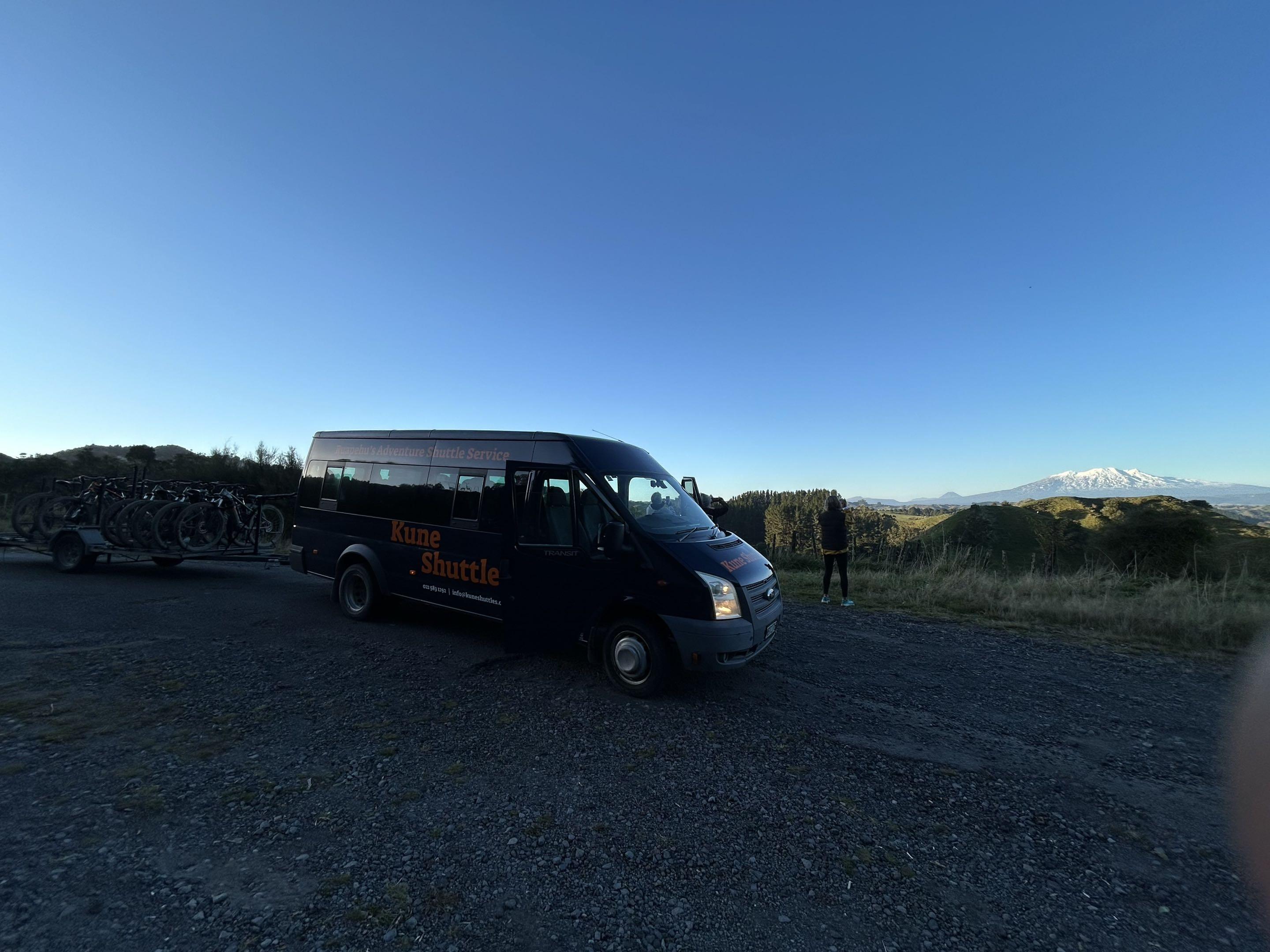 Kune shuttle van with bikes at dusk